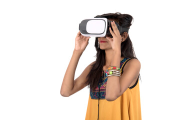 Beautiful girl looking though VR device. Young girl wearing virtual reality goggles headset.