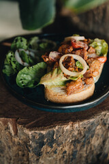 Toast with crispy fried spicy chicken, onion and sause