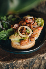 Toast with crispy fried spicy chicken, onion and sause