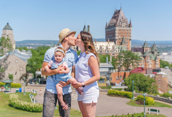 nice Couple with baby in front of Chateau Frontenac at Quebec city in summer season