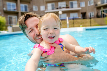 Fototapeta na wymiar father with the child girl in the pool