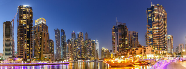Dubai Marina skyline architecture buildings travel at night twilight in United Arab Emirates panorama