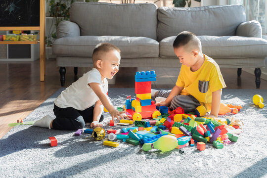 Two Boys Are Playing With Toys
