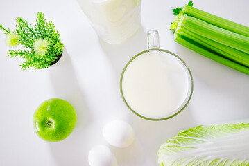 set of products for healthy eating white and green layout on the kitchen table.