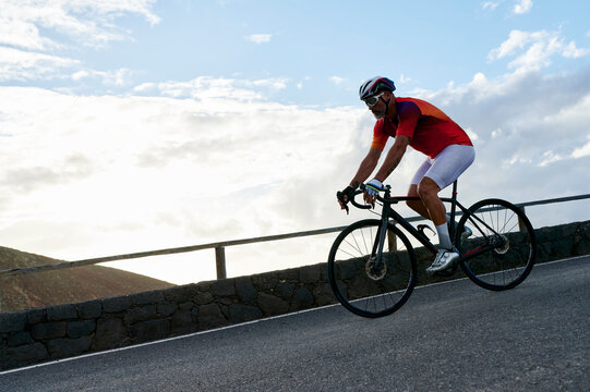 Mature man riding down a mountain road