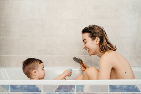 Happy Mom and baby taking bath 