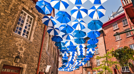 Lot of Umbrellas in Petit Champlain street Quebec city Canada - obrazy, fototapety, plakaty