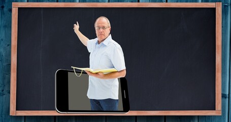 Composition of male school teacher on smartphone screen over blackboard