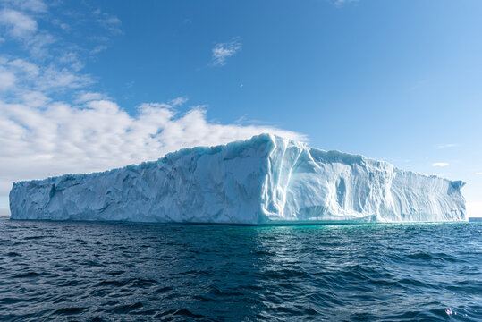 Massive iceberg in rippling cold sea
