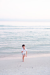 Fototapeta na wymiar Little Boy Playing on Beach