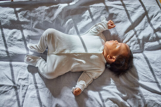 African american cute baby  sleeping on bed at home