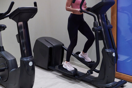 Woman using exercise machines in a gym