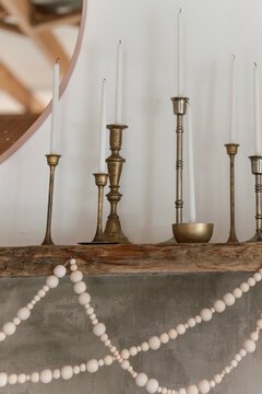 modern eclectic  fireplace mantle with brass taper candle