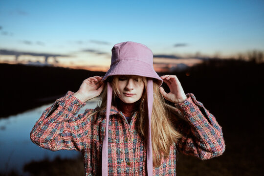 Portrait Of A Woman Puting Her Hat On
