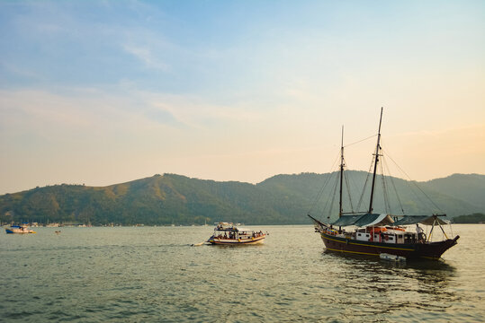 Boats on the sea with mountains behind
