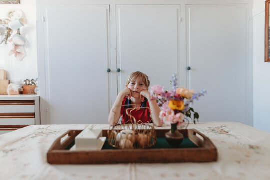 flowers on a table with seated girl