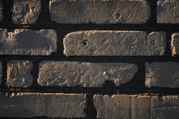 Brick background. Brickwork illuminated by side sunlight. 