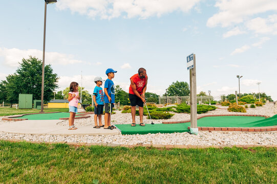 Leisure game of miniature golf at the park. 