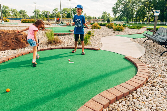 Children trying for a hole-in-one. 