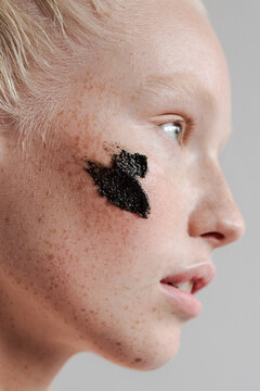 Young Model With Black Scrub On Face