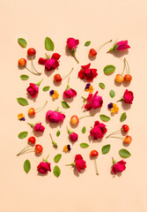 Flat lay, copy space. Summer composition with  flowers, leaves and berries sweet cherry on a beige background.
