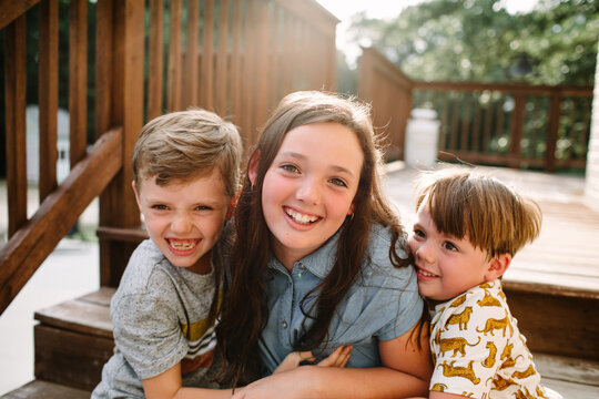 Siblings Sitting Together Outside