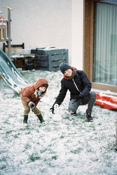 Father and son having fun outdoors in the snow