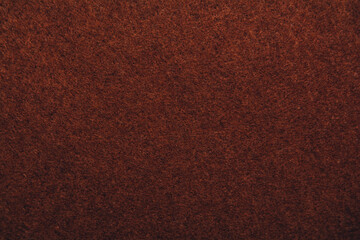 A close up of brown felt material background. Textured fabric backdrop. Copy space