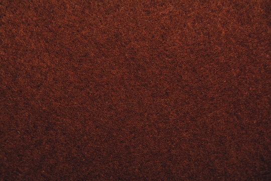 A close up of brown felt material background. Textured fabric backdrop. Copy space