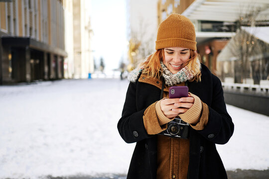 Woman using phone winter