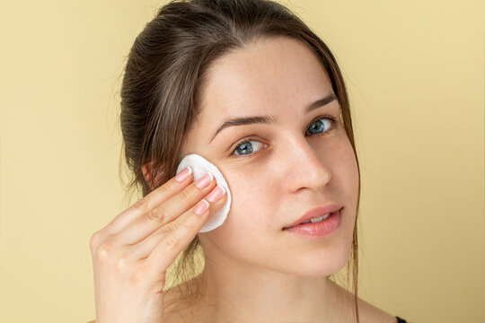Studio portrait of a woman cleaning face 