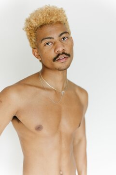 Young man looking at the camera shirtless