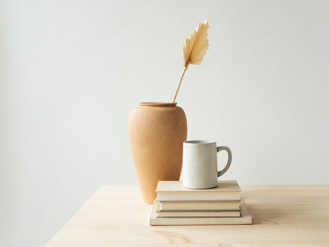 Minimal Table Scene with Pottery and Books 