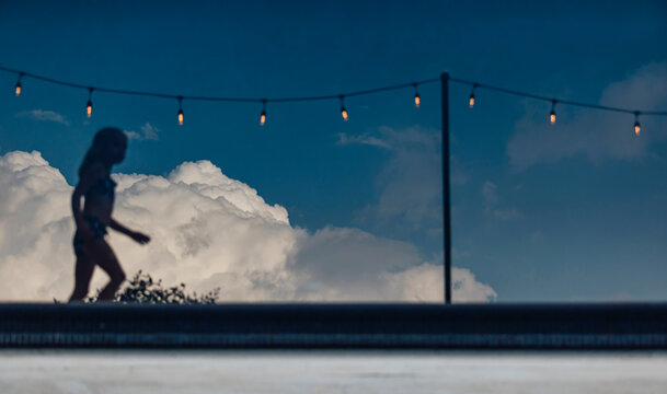 Reflection of Young Girl in Pool of Water with Cloud 