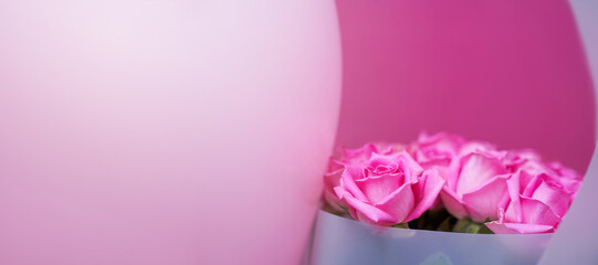 A beautiful bouquet of pink roses on a pink background, natural flowers, banner with copy space. High quality photo