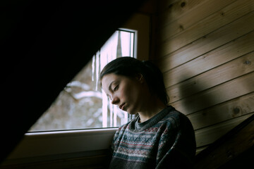 portrait of a sad girl at the window
