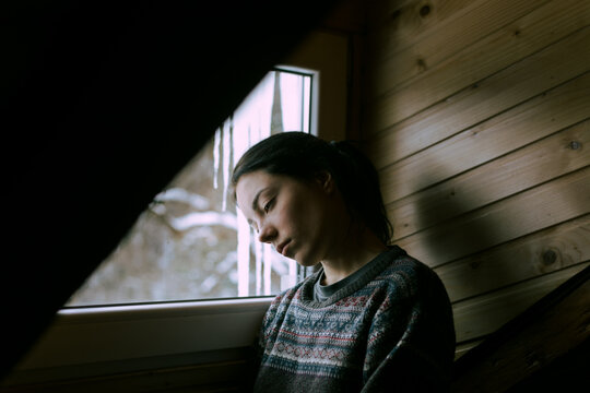 portrait of a sad girl at the window
