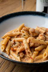 Close up of ground meat cheesy penne in a restaurant