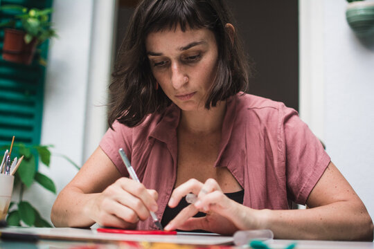 Woman concentrated creating a piece of jewelry