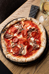 Huge hot meat pizza, appetizing bright and beautiful photo for social media