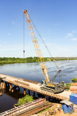 Heavy crane on a temporary bridge.