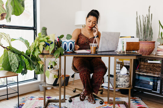 An African American woman working from her home office. 