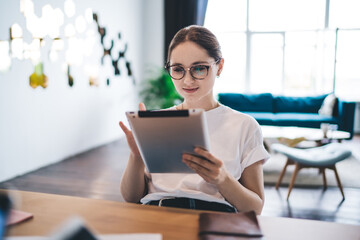 Cheerful young woman using tablet