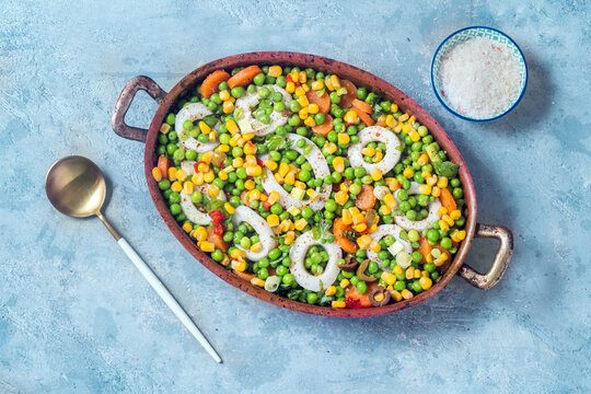 Green peas and calamari stew in casserole