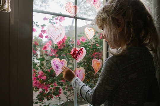 Colourful painted hearts on a window