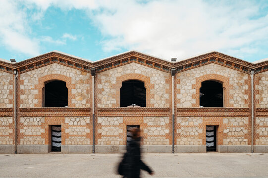Blurred stranger against building.