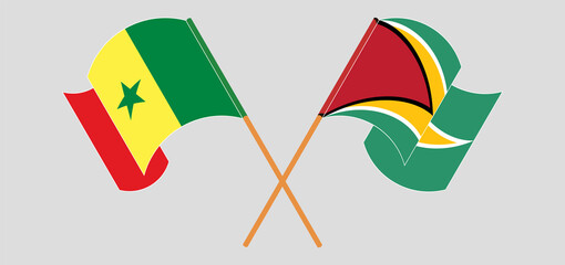 Crossed and waving flags of Senegal and Guyana