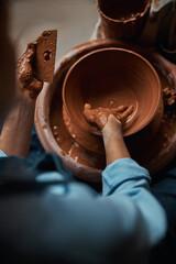 Charming elegant female hands modeling clay bowl in pottery workshop