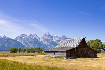 Fototapeta na wymiar Wooden barn with Grand Teton mountain range in background