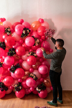 Unknown male creating decoration from air balloons 